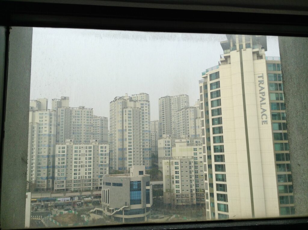 view of tall high rise buildings inside of small studio apartment