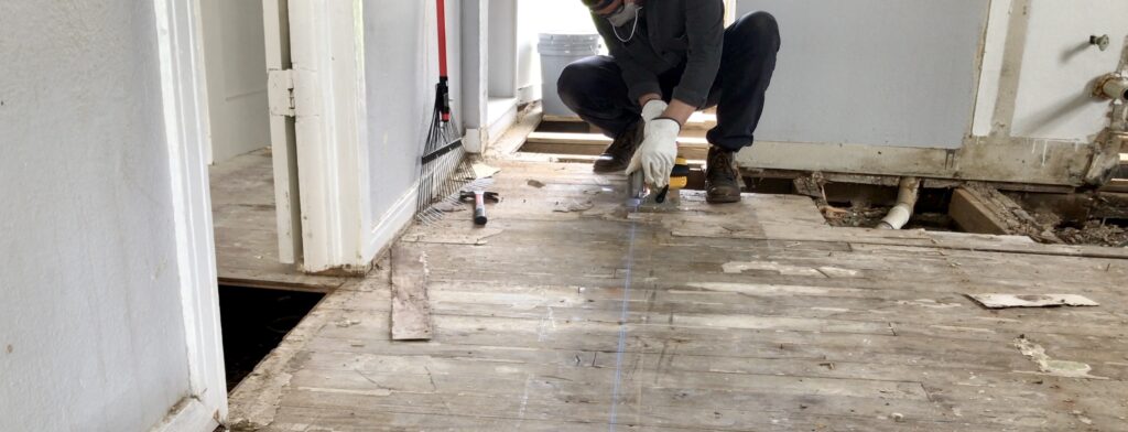 man cutting hardwood floors
