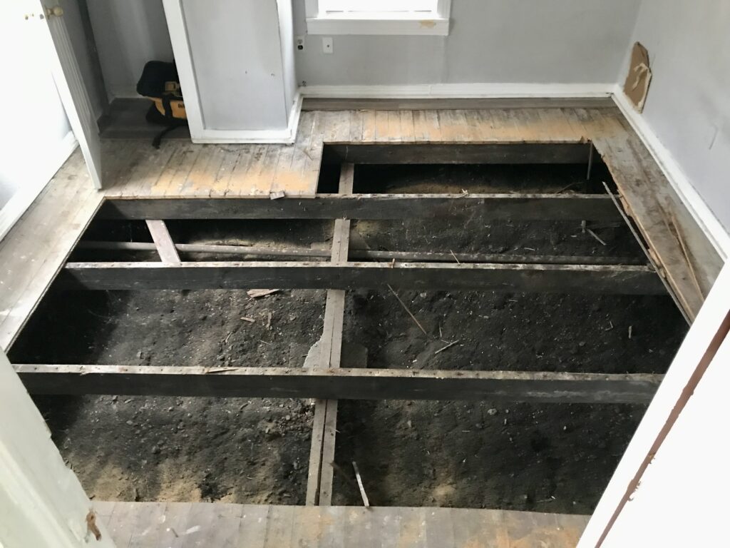 dirt exposed under the flooring