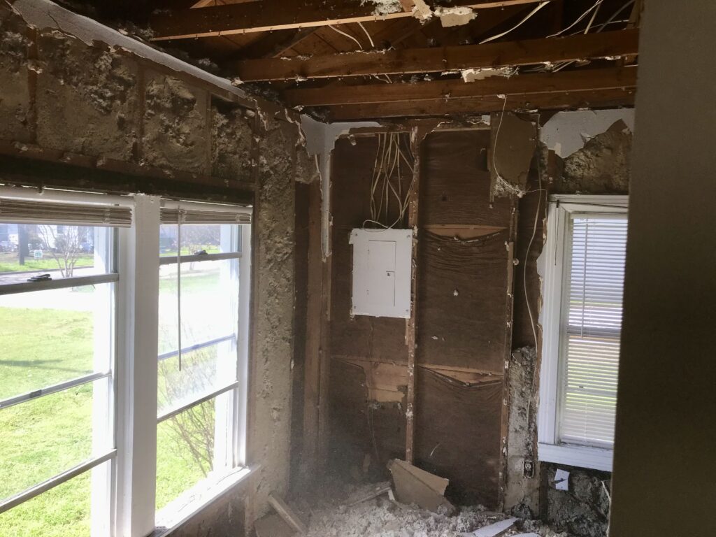 drywall torn out and insulation exposed in fixer upper