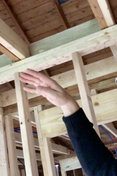 man pointing up toward ceiling frames