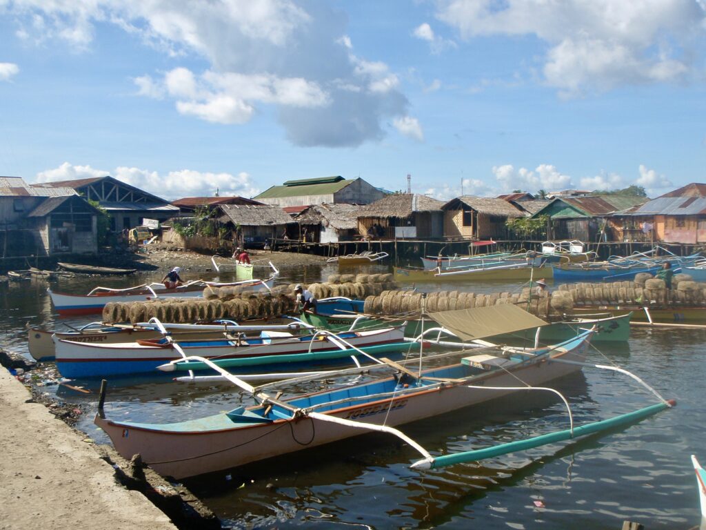 hut houses and boats on water