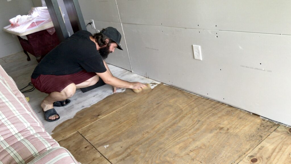 man cleaning plywood floors