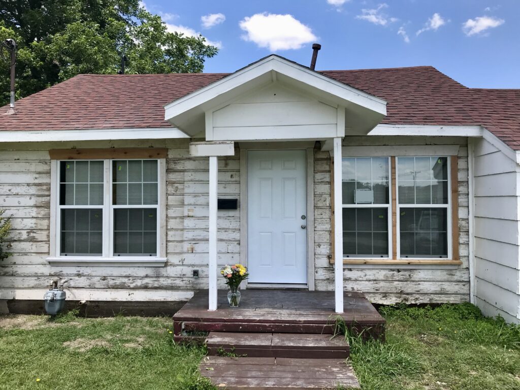 small fixer upper cottage with old original wood siding