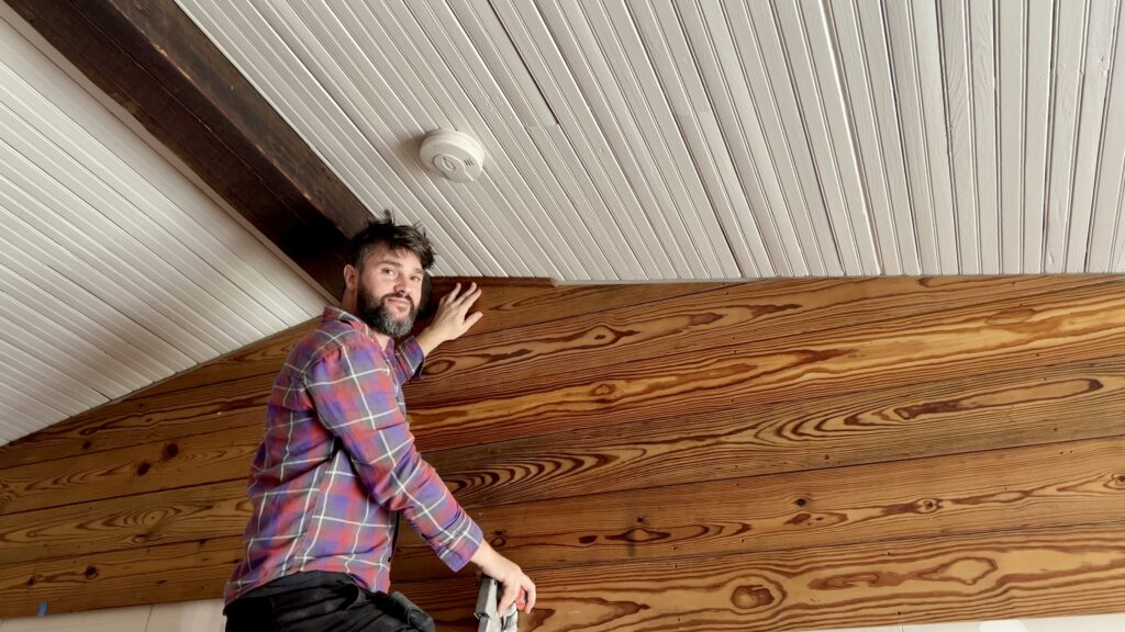 man installing antique shiplap on walls