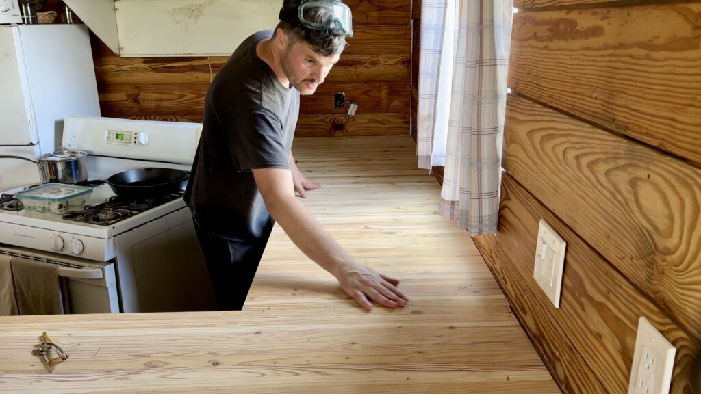 man installing custom built butcher block countertop 