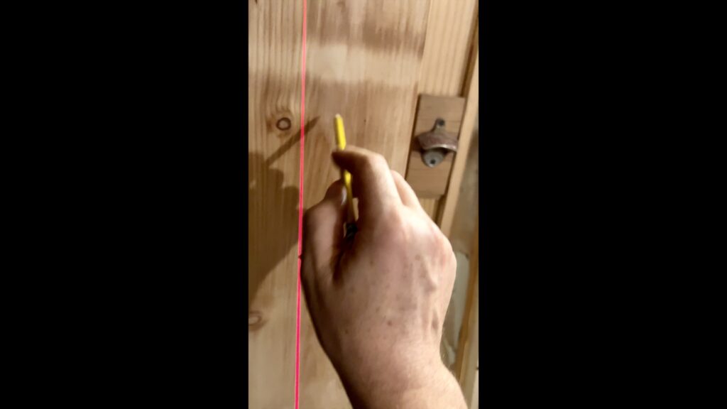 man's hand and laser level building custom door jambs for vintage doors
