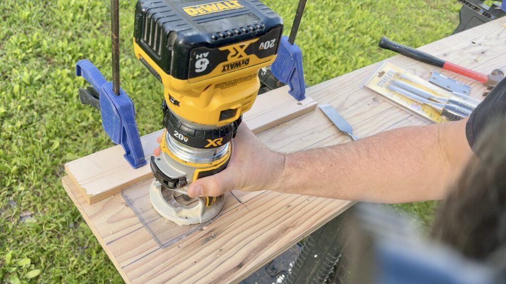 man using woodworking router for door jamb hinges 