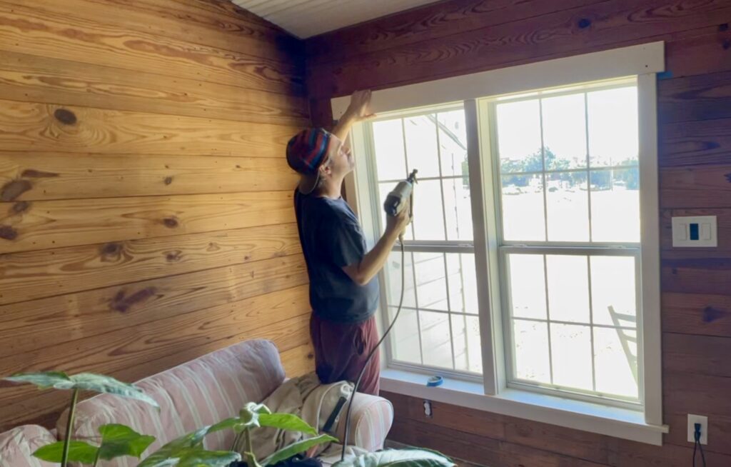 man building custom trim for windows