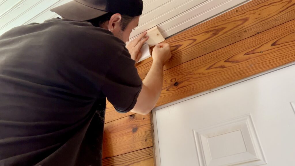 man working on custom trim for vaulted ceiling