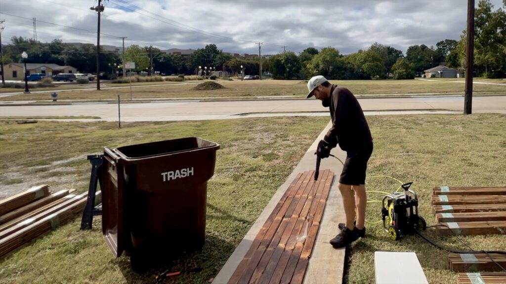 man power washing reclaimed wood flooring