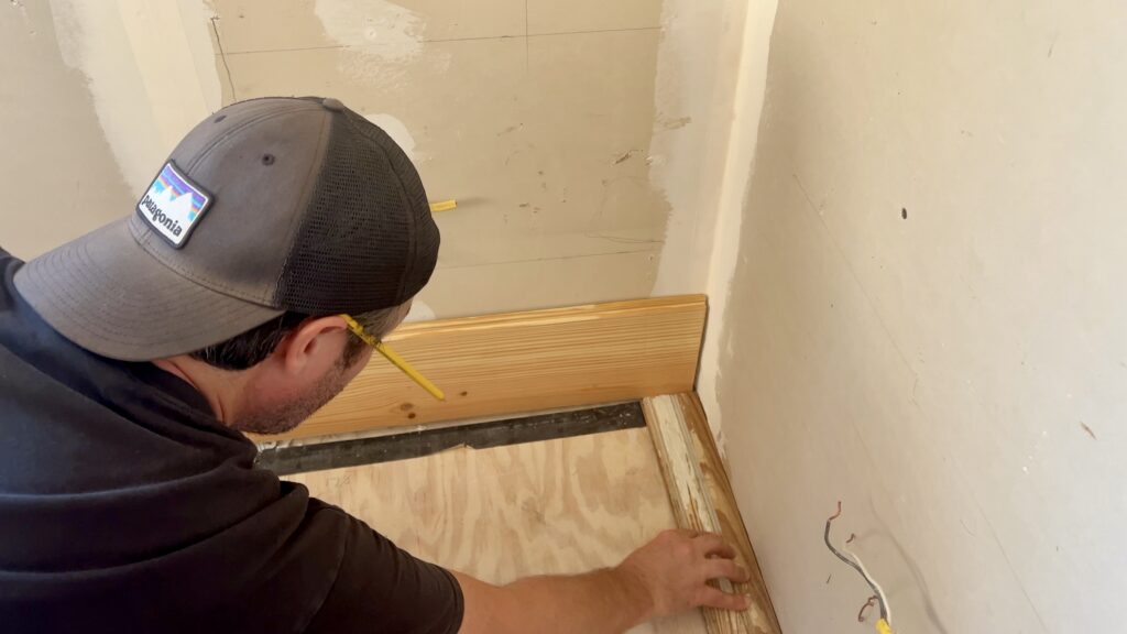 man installing new shiplap on wall